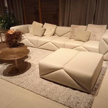 Sofas, upholstered poufs, and coffee table by Malerba