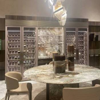 Round table, chairs, and wine cabinet by Visionnaire